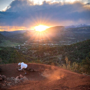 Mountain biker shredding a burm at sunset at Durango Mesa Park